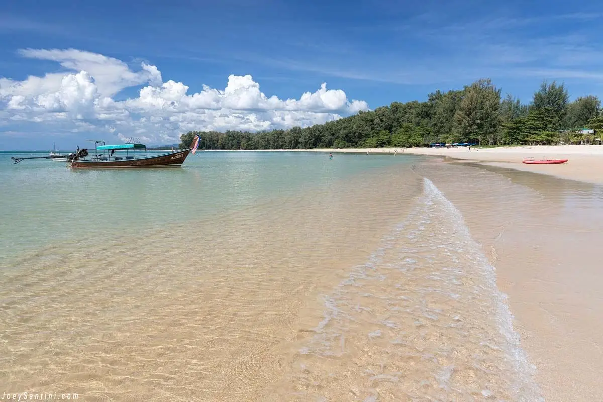 Clear water and a longtail boat off Nai Yang Beach
